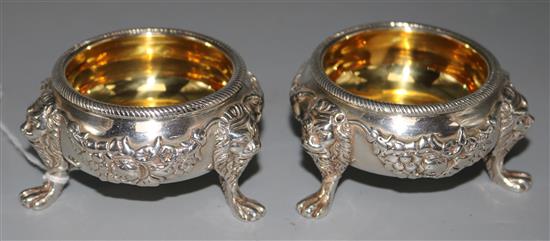 A pair of George III silver bun salts with applied swags and lion masks on paw feet, London 1812, Story & Elliott, 11.5 oz.